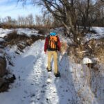 Man snowshoeing on a trail