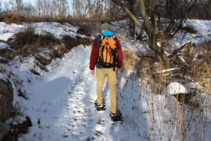 Man snowshoeing on a trail