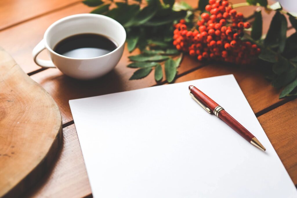 Notepad and coffee on a table - ready to create goals