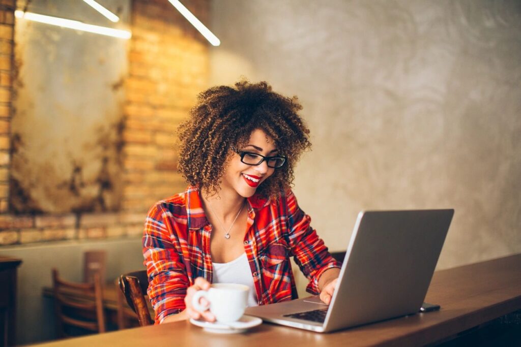 Woman at laptop working to Stay Motivated for Side Hustle